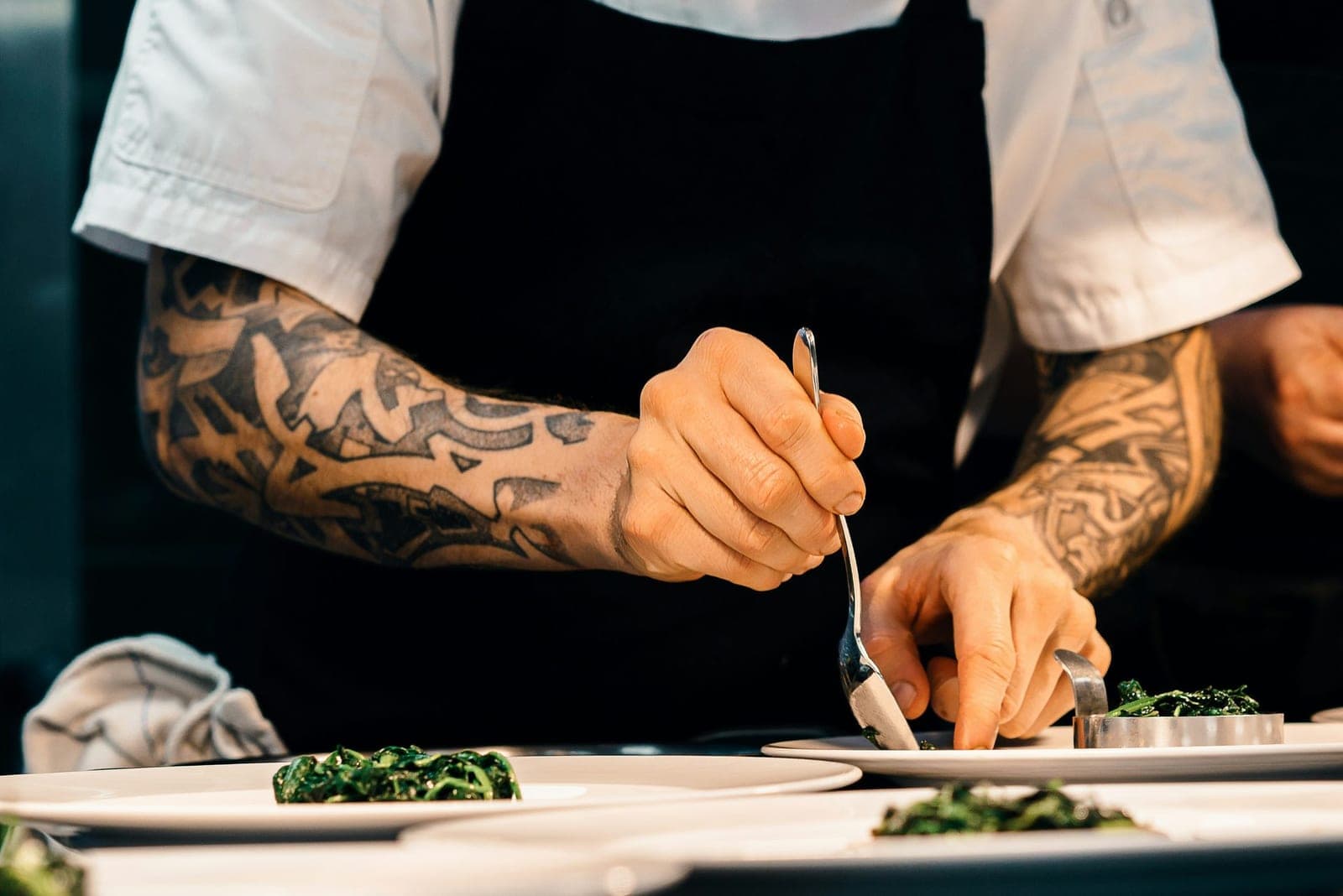 Chef plating a finished dish in a professional kitchen