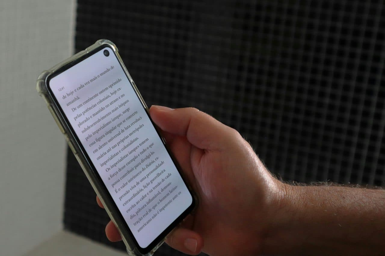 Hand holding a smartphone scanning a document